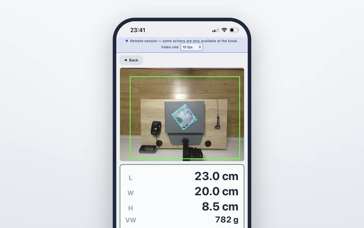 The EVS 140 remote view on a phone: the live camera image of a polybag on the scale and its measurement, 23.0 × 20.0 × 8.5 cm, 20 g.